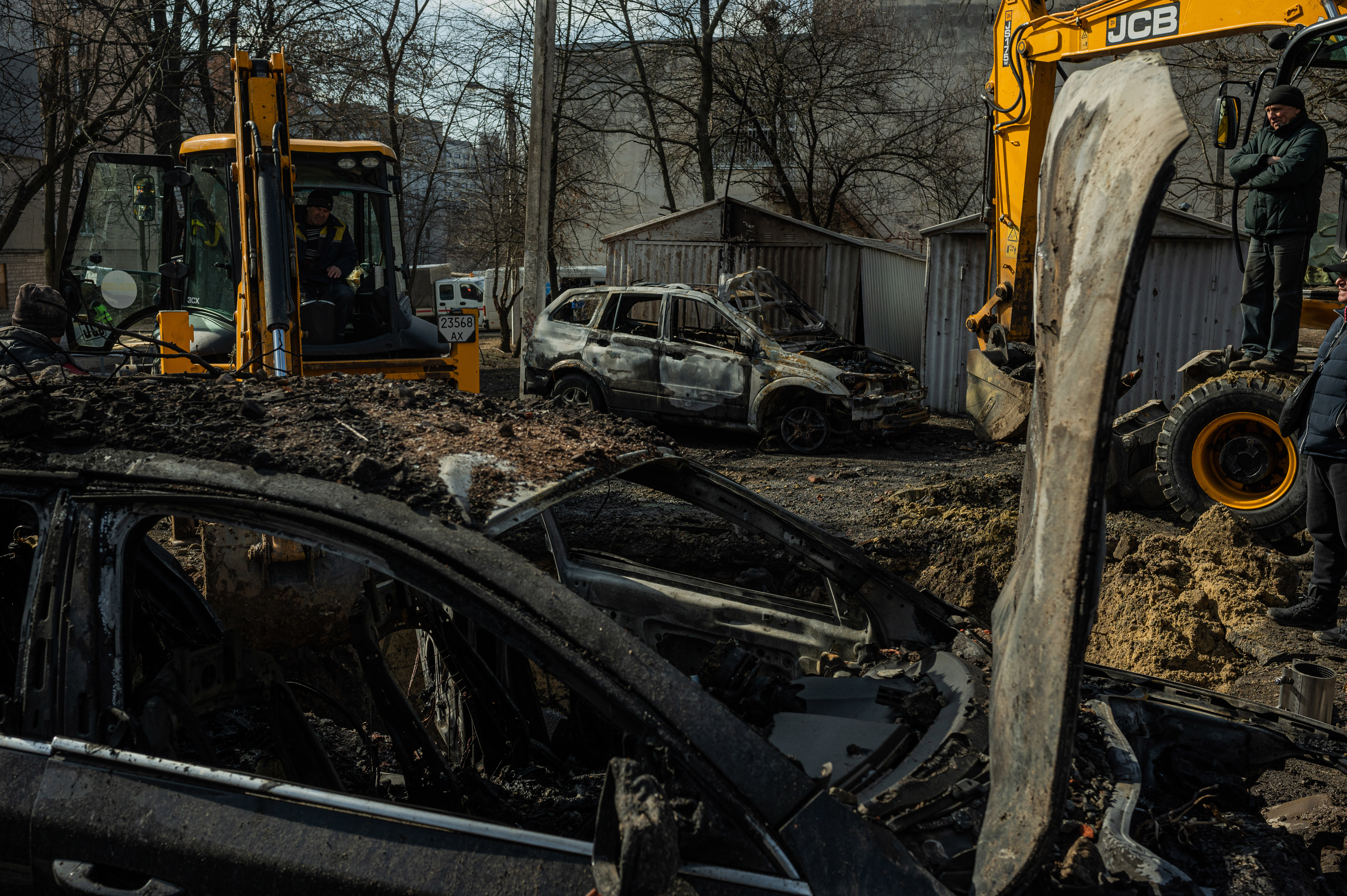 Municipal workers clear a residential courtyard after a nighttime airstrike. February 2024. ©Denis Vėjas