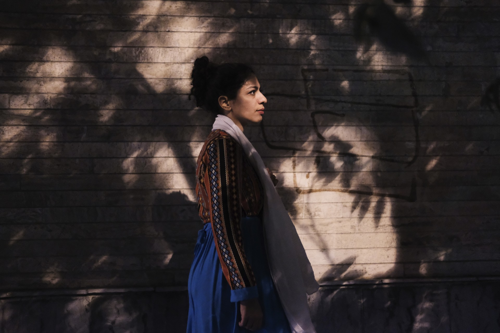 Masi Abolhassan walking in the streets of Tehran without a compulsory hijab. Iran, 2018. ©Mykolas Juodelė