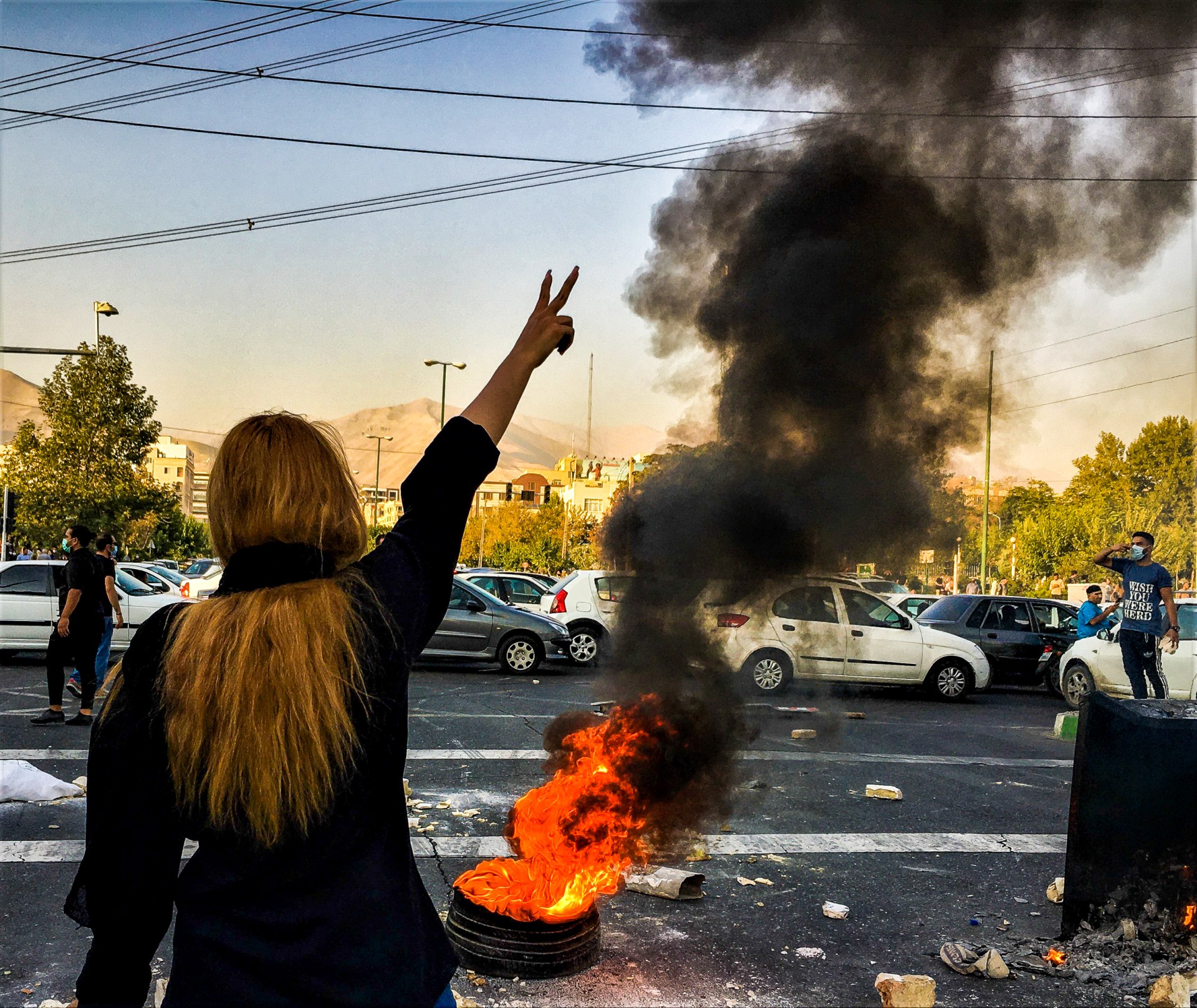 People gather during a protest for Mahsa Amini, who died after being arrested by morality police allegedly not complying with the strict dress code in Tehran, Iran. ©Middle East Images