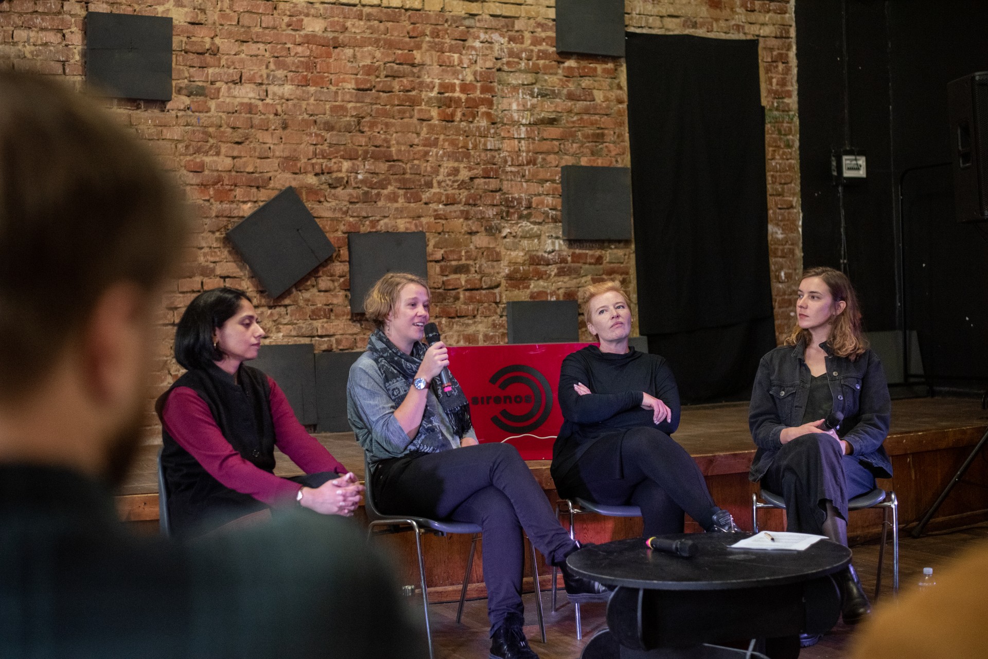 Panel speakers, later joined by the podcast listeners (from the left): Runa Chakraborty Paunksnis, an associate professor, teaching gender Studies at Kaunas University of Technology (KTU); Eglė Murauskaitė, a senior researcher at the University of Maryland, working with unconventional security threats; Yana Ross, a resident director at the Lithuanian National Theater. The conversation was moderated by journalist Ieva Balsiūnaitė. ©Severina Venckutė Panel speakers, later joined by the podcast listeners (from the left): Runa Chakraborty Paunksnis, an associate professor, teaching gender Studies at Kaunas University of Technology (KTU); Eglė Murauskaitė, a senior researcher at the University of Maryland, working with unconventional security threats; Yana Ross, a resident director at the Lithuanian National Theater. The conversation was moderated by journalist Ieva Balsiūnaitė. ©Severina Venckutė