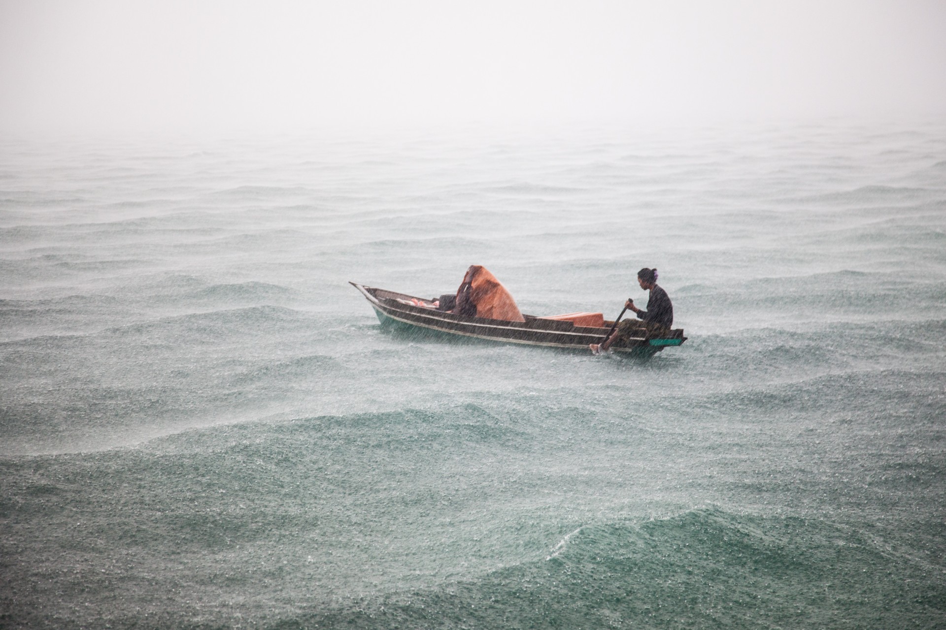 Two women and their children near the island of Mabul, where they sold freshly caught fish to tourists.