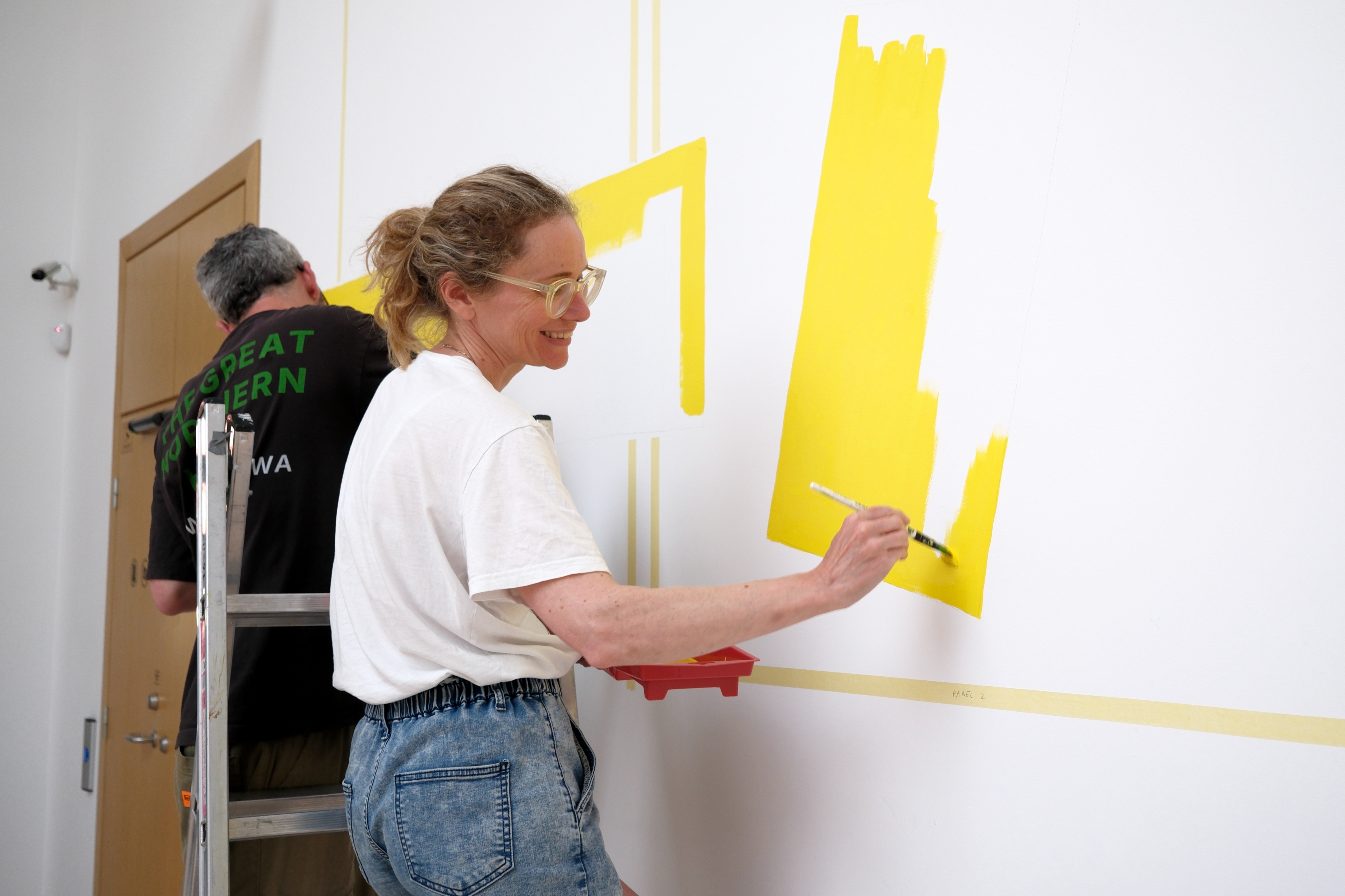A wall painting in preparation for the opening of 