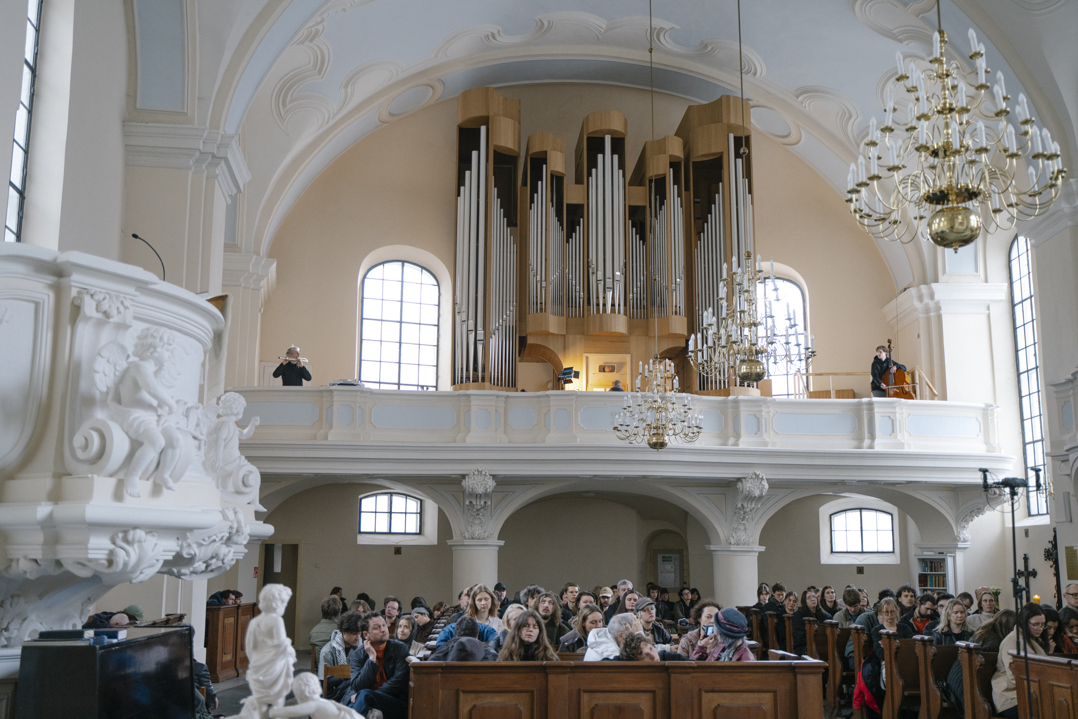 Kristupas Gikas, Gediminas Stepanavičius and Romain C. Bertheau performing Liepa Vozgirdaitė's composition at Jauna Muzika 2026 at the Evangelical Lutheran Church in Vilnius. ©Ilmė Vyšniauskaitė