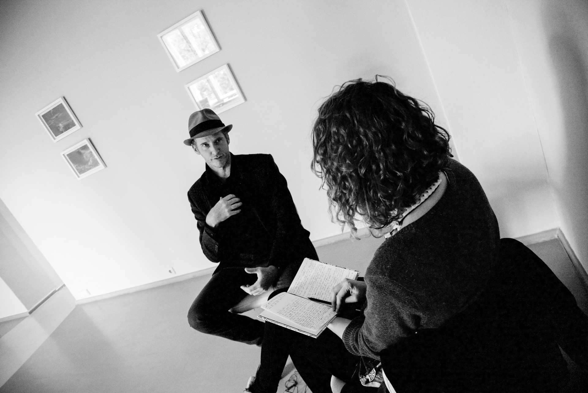 Tomas Van Houtryve and Berta Tilmantaitė talking at his photography exhibition in 