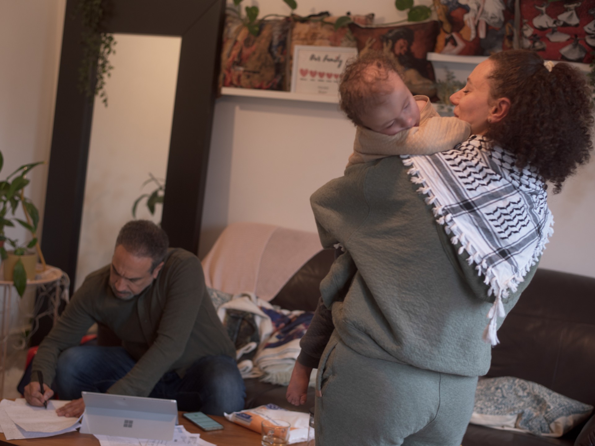 Rasha's husband, Mohamed, is filling out paperwork for their refugee visas. It's the last day to send out the correct documents, so the family is tense. ©Julija Stankevičiūtė