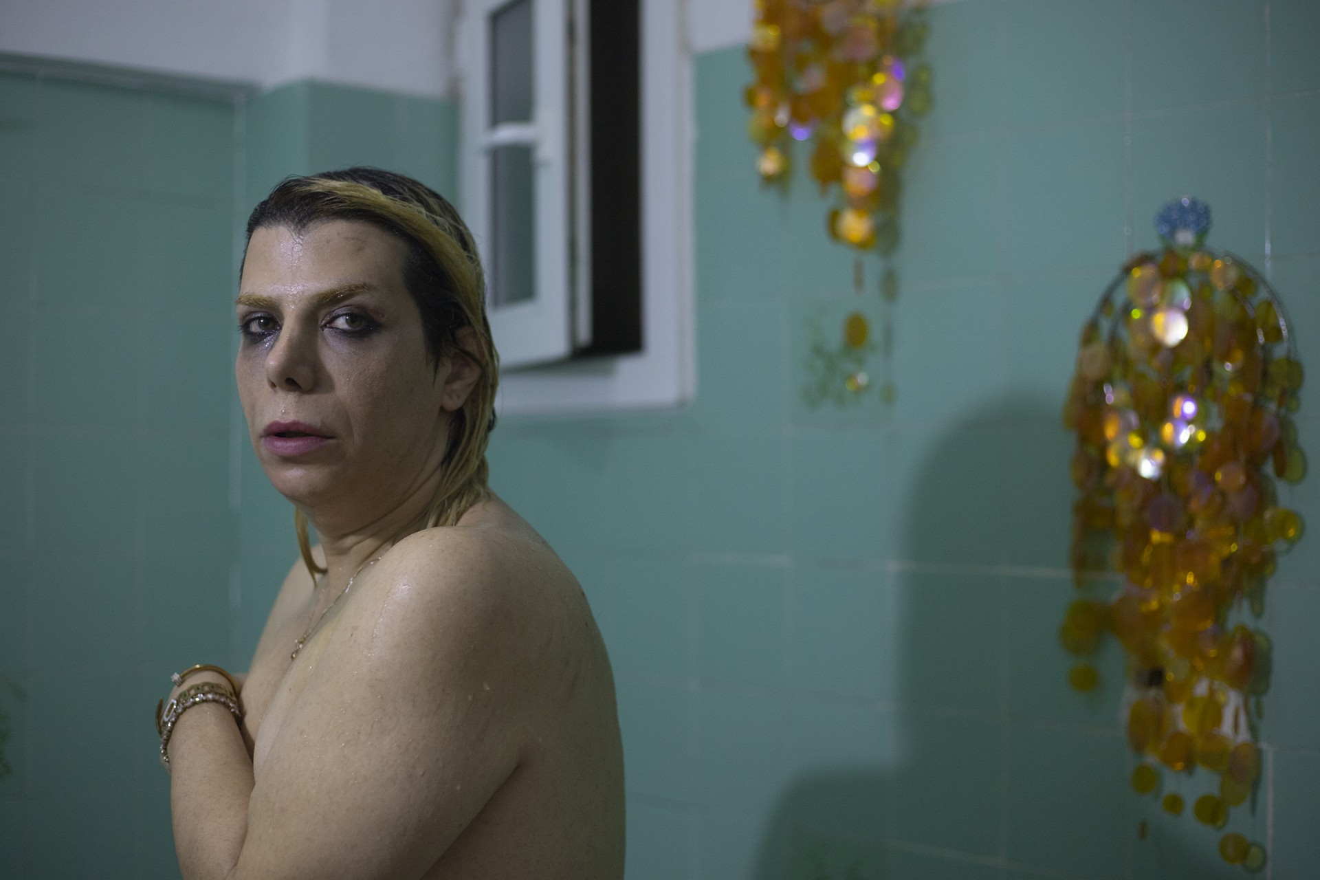 Baran takes a shower before going to bed. She puts a lot of effort to support others and usually her place is a shelter for the newcomer LGBTQ refugees.