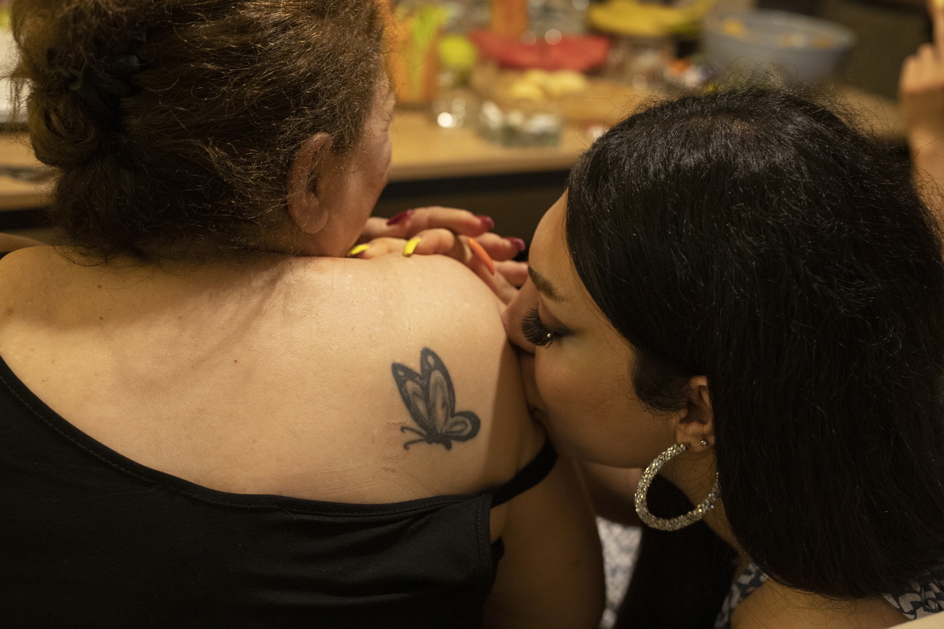 Haleh's aunt shows the butterfly that Haleh tattooed for her a few years ago.