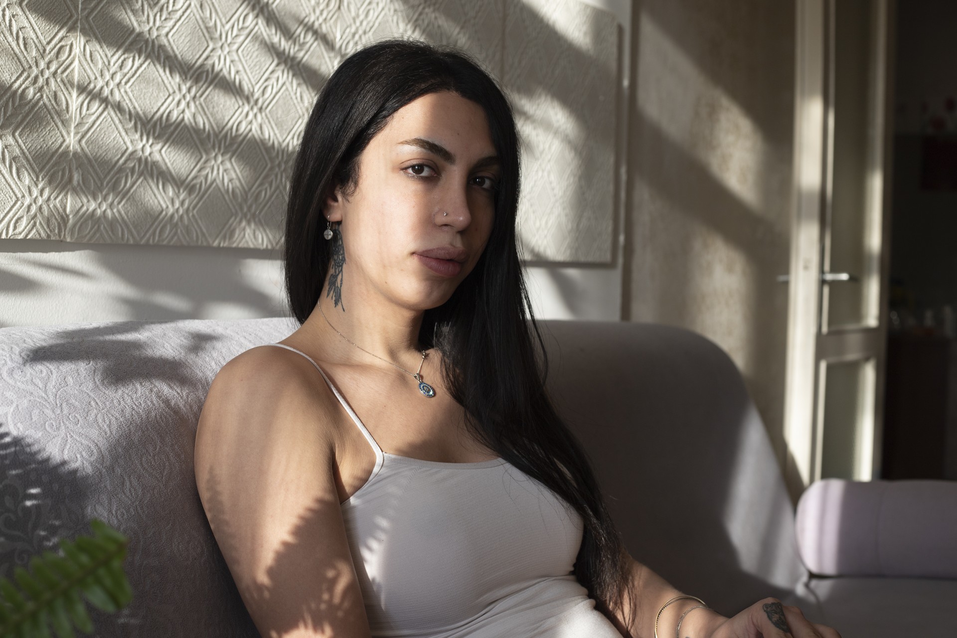 Haleh is chilling out in the living room after finishing her job in the barbershop.