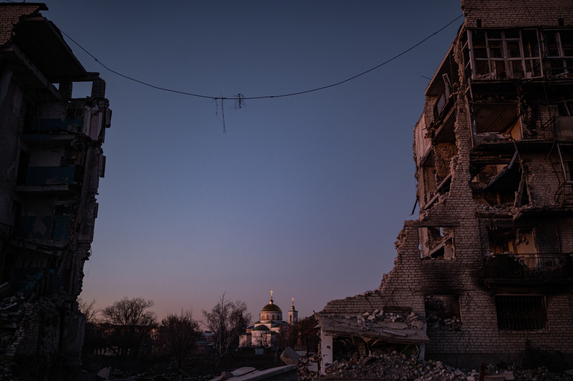 Iziumas. Pro skylę sugriautame name matosi cerkvė. ©Denis Vėjas